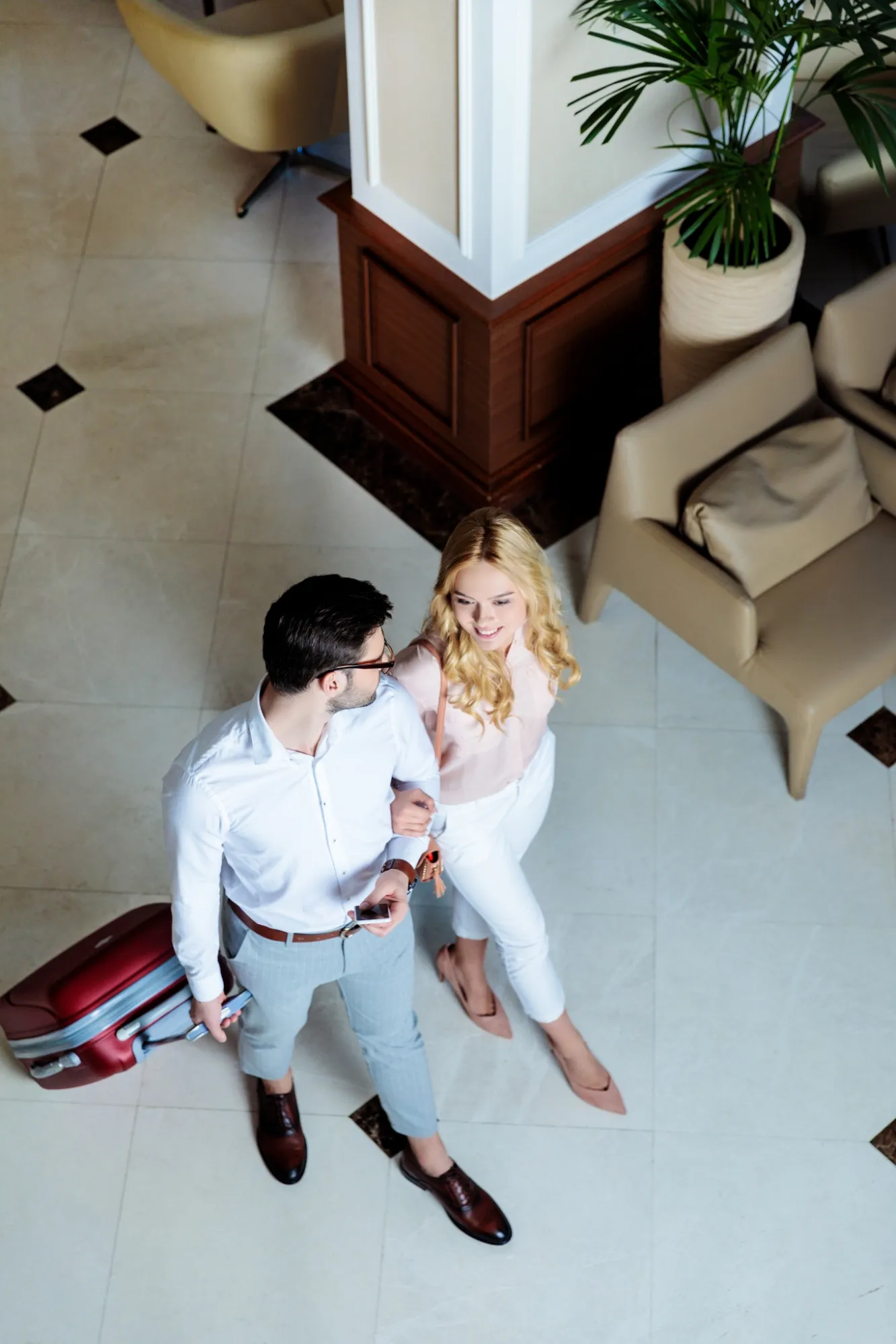 Travelers standing in a hotel lobby with luggage