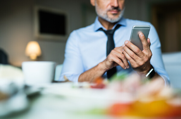 A business guest consults the mobile concierge from his hotel room.