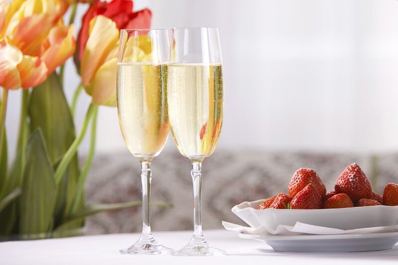 Champagne glasses and strawberries used for romance package room rate