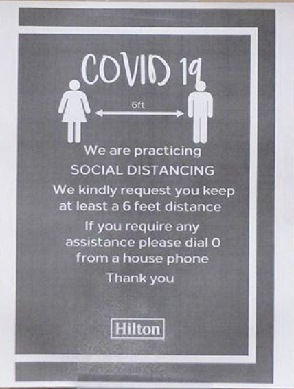 Sterile gray hotel signage expressing COVID-19 protocols