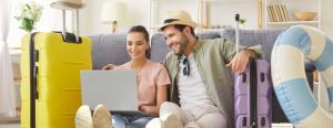 A happy couple make a summer hotel booking online