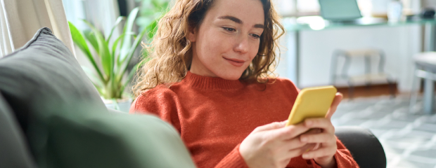 Woman using a mobile phone to book a hotel stay