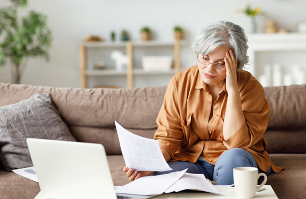 A tired hotel owner muddles through paperwork at home when she should be relaxing!