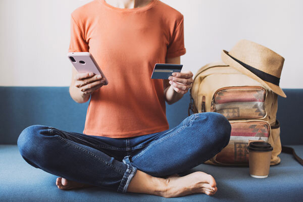 A woman makes a hotel booking on her mobile device