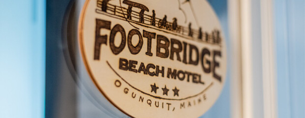 Sign showing Footbridge Beach Motel logo