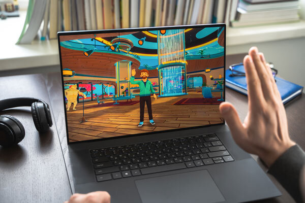 A man using a laptop waves at an avatar in Decentraland.