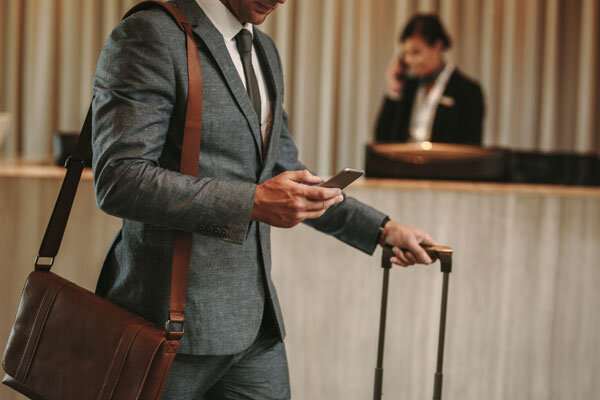 A businessman bypasses the front desk with mobile self-check-in.