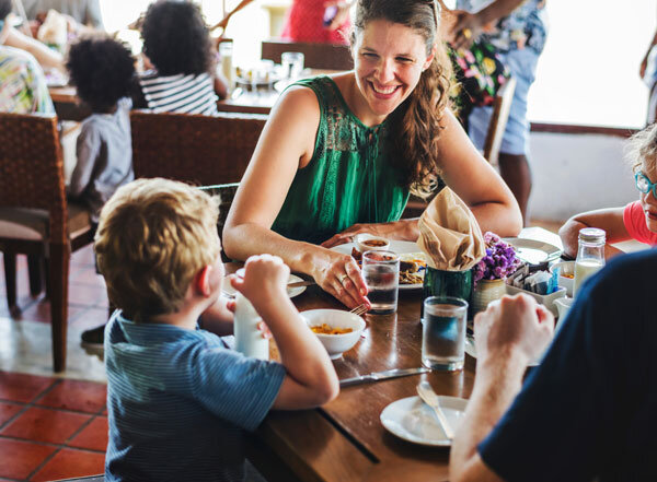 A young family enjoys a healthy hotel breakfast