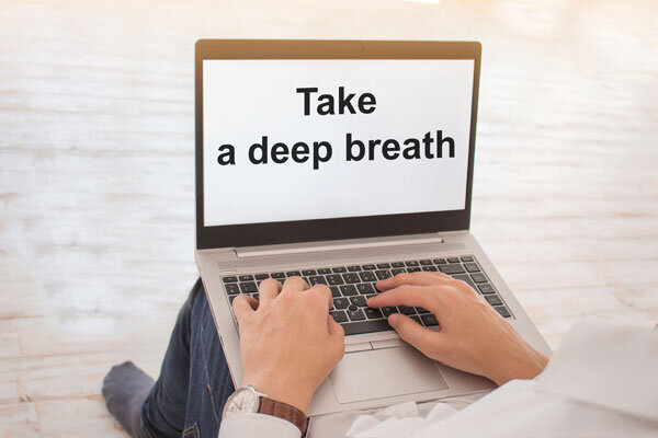 A computer screen reads, "take a deep breath."