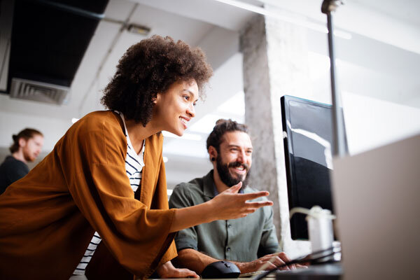 Smiling hotel staff using hotel software that makes daily operations easier.