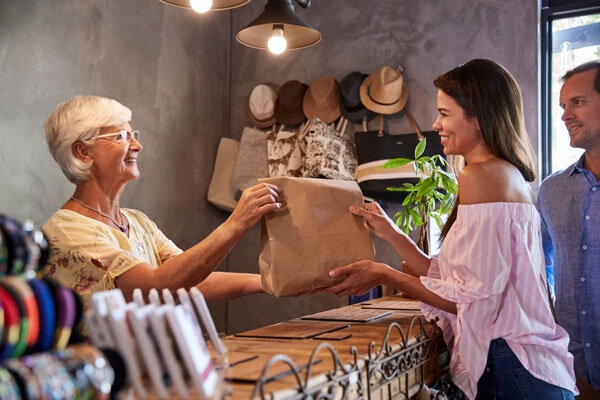 Guests purchase a memento of their trip from a hotel gift shop.