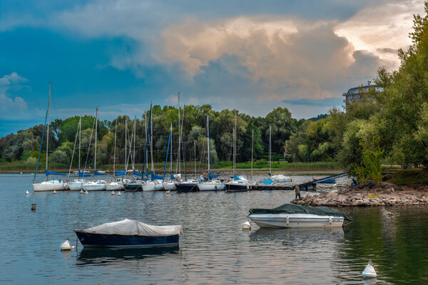 A small marina full of boats on the lake.