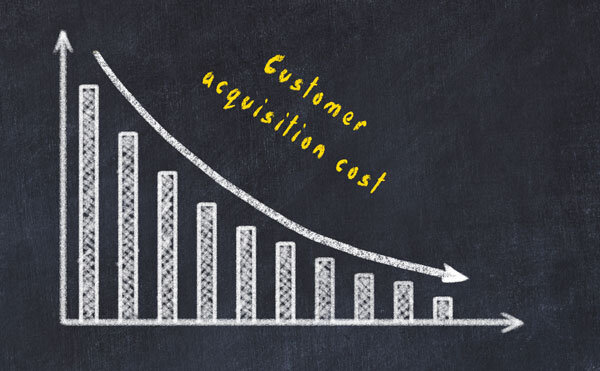 A graph on a chalkboard shows decreasing CAC.