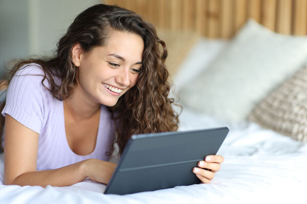 A hotel guest uses the digital guide on her tablet in the comfort of her hotel room.