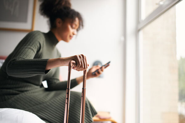 A guest uses the hotel app to make a request upon arriving to her room