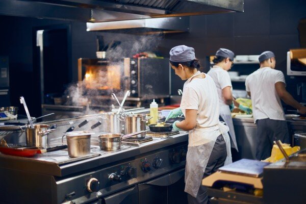 Kitchen staff create culinary delights in a well equipped and organized hotel kitchen.