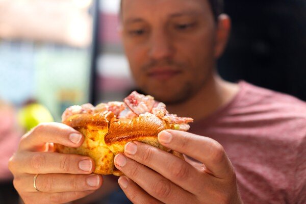 A guest savours a lobster roll.