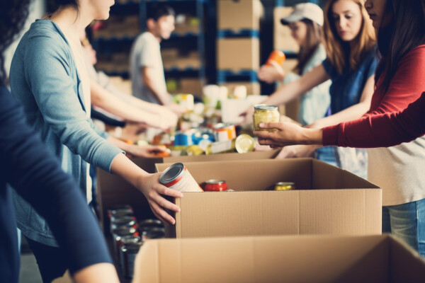 Volunteers help sort donated food items.