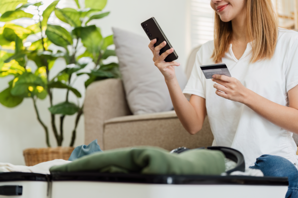 A happy guest books her ideal hotel room direct online using her mobile.