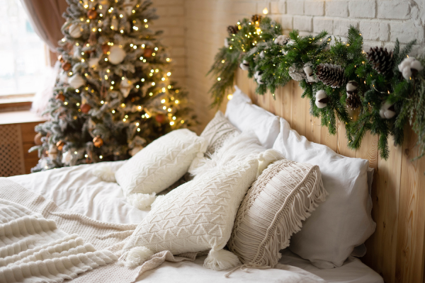 A cozy winter hotel room with seasonal décor and snowy views.